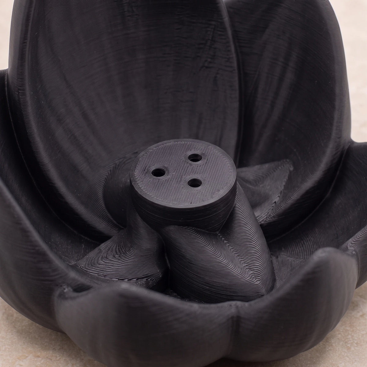 Gros plan sur les trois emplacements du porte-encens Lotus Noir